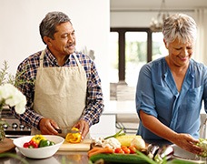 An older couple preparing healthy food to eat