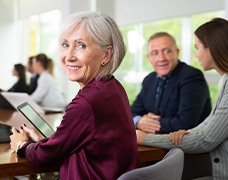 A senior businesswoman working in a conference room