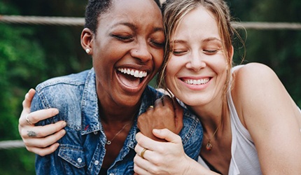 Dental implant patient in DeSoto talking with friends