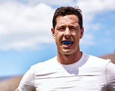 Man wears athletic mouthguard