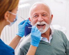 Man smiles at dentist